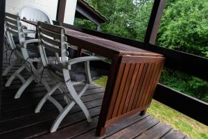 two chairs and a table on a deck at Le Chalet de Gaume in Virton