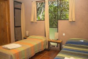 a hotel room with two beds and a window at Las Rukas in San Javier
