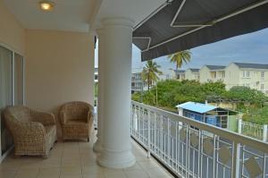 a balcony with two chairs and a view of the ocean at Maurer Loisirs Ltee in Trou aux Biches