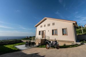 a motorcycle parked in front of a house at TOURIÑÁN MAR in Muxia