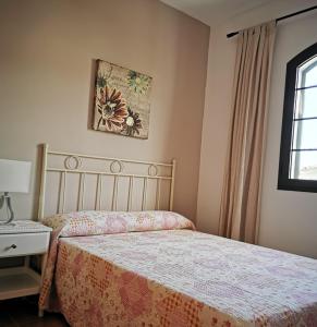 a bedroom with a bed and a lamp and a window at Cosy duplex in Agaete with WIFI in Agaete