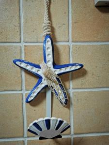 a blue and white star ornament hanging on a wall at Cosy duplex in Agaete with WIFI in Agaete
