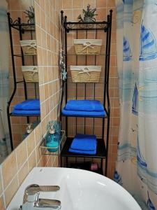 a bathroom with a tub and a sink and a mirror at Cosy duplex in Agaete with WIFI in Agaete