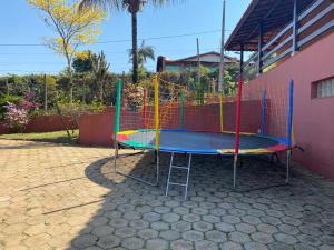 a playground with a trampoline in a yard at Chácara Cantinho que Deus me Deu in São Paulo