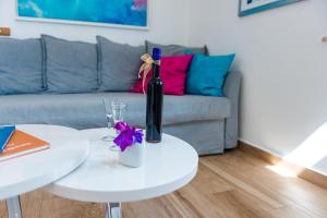 a bottle of wine on a white table in a living room at San Pietro apartment in Dubrovnik