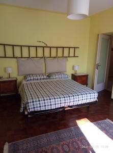 a bedroom with a large bed with two pillows at Il Barucin in Villar San Costanzo