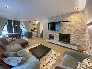 a living room with a couch and a fireplace at Olympic Oasis in Jahorina
