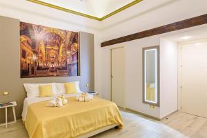 a bedroom with a bed with a painting on the wall at Barlaman Luxury Rooms in Palermo