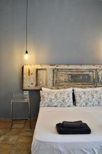 a bedroom with a white bed with a wooden headboard at Il Miracolo in Naples