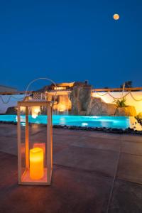 a glass box with a yellow object sitting on a sidewalk at La Belle Vie - Santorini - Adults Only in Kamari