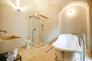 a bathroom with a sink and a toilet and a shower at BAYIT Charming Place in Polignano a Mare