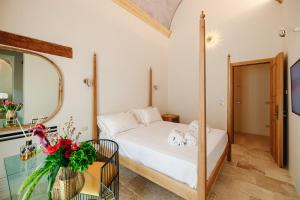 a small bedroom with a bed and a mirror at BAYIT Charming Place in Polignano a Mare