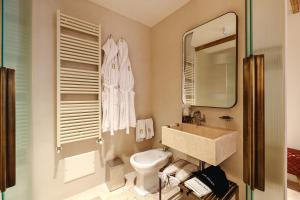 a bathroom with a sink and a toilet and a mirror at BAYIT Charming Place in Polignano a Mare