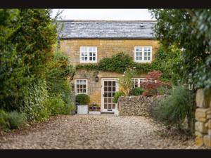 an old brick house with a stone driveway at Wisteria Cottage , Pretty Cotswold Cottage close to Chipping Campden in Weston Subedge