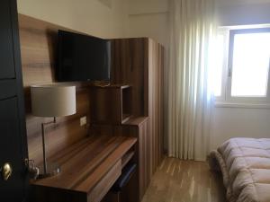 a bedroom with a bed and a television on a wall at Villa Santoro in Ariano Irpino