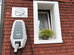 a house with a security camera on the side of it at Café Pension zum Jäger in Buchboden