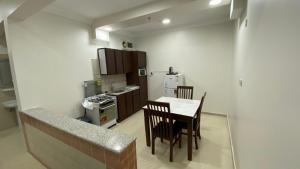 a kitchen with a table and chairs in a room at الرؤية للشقق المخدومة - إقتصادي - Alruwyah For Serviced Apartments - Economy in Najran