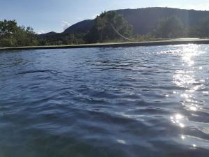 a large body of water with mountains in the background at 1832 La Rabassière in Malaucène