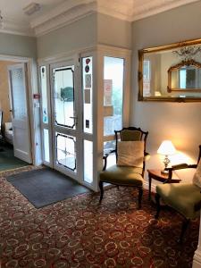 a living room with a chair and a sliding glass door at Bryn Noddfa in Morfa Nefyn