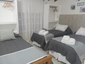 a room with two beds with towels on them at Estrella Polar in Ushuaia