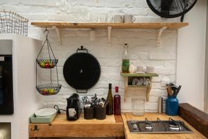 a kitchen with a counter with a sink and a stove at Vinonima Vendégház in Hegymagas