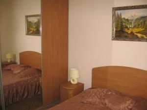a bedroom with two beds and a mirror and a mirror sqor at Vian Guest House in Truskavets