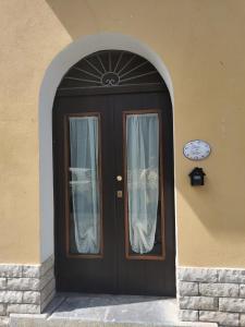 a black door with curtains on a building at Casa del Porto in Scario