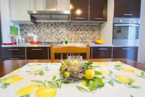a bowl of fruit on a table in a kitchen at Apartment Lemon in Catanzaro