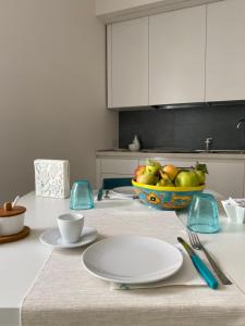a kitchen with a table with a bowl of fruit on it at Aura Marina Casa Vacanze in Polignano a Mare +41 photos