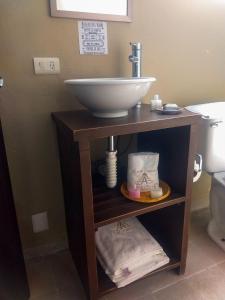 a bathroom with a sink on a wooden stand at Hotel Boutique Acocalli in San Juan Teotihuacán