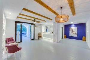 a living room with a purple chair and blue wall at The Hello Hotel in Gümbet