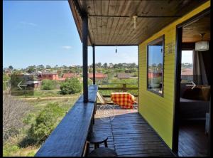 a porch of a house with a view of a field at Fama in Punta Del Diablo