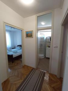 a room with a bathroom and a bedroom with a bed at Apartman "Plitvice and You" in Plitvička Jezera