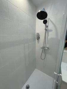 y baño con ducha con cabezal de ducha. en Le cottages des remparts - le lodge en Boulogne-sur-Mer