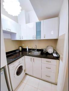 a kitchen with a sink and a washing machine at Delta Sharm Holiday in Sharm El Sheikh