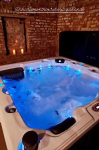 a jacuzzi tub with blue lighting in a room at Charlemont House Exclusive Hire Perfect for Groups of 8 to 23 persons in Moy