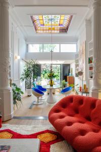 a living room with a red couch and a glass ceiling at Island in Island, B&B boutique, Design et Vintage in Namur