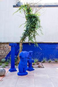 a blue fire hydrant sitting next to a blue pole at Island in Island, B&B boutique, Design et Vintage in Namur