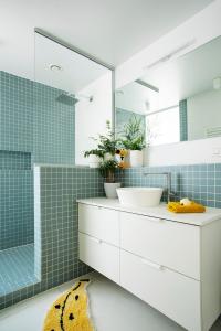 a bathroom with a sink and a mirror at Island in Island, B&B boutique, Design et Vintage in Namur