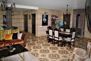 a living room with a couch and a table at Forest house for family in Lebeniškiai +28 photos
