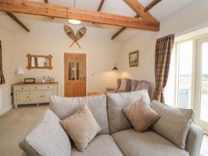 a living room with a couch and a table at Horsley Cottage in Consett