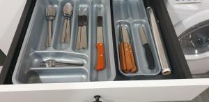 a drawer filled with silver utensils and a sink at Apartamentos Leman in Benicarló +45 photos