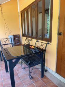 a ping pong table on the porch of a house at Dikachaya Hostel in Chaweng