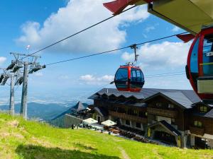 a ski lift above a building on a mountain at Yager Chalet in Poiana Brasov