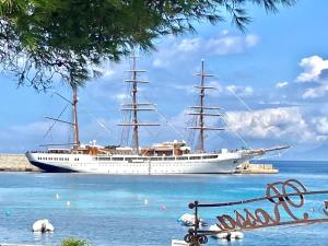 a large ship in the water next to a beach at L'Isula Rossa in LʼÎle-Rousse