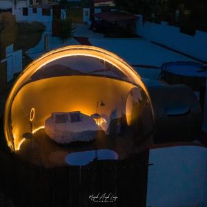 a round room with a light in the middle of it at Burbuja AntiSaturno - Glamping Alto Tajo in Ablanque