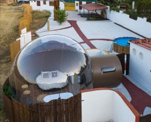 a room with a bed inside of a building at Burbuja AntiSaturno - Glamping Alto Tajo in Ablanque