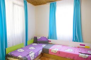 a bedroom with two beds with hello kitty sheets at Бунгала Камена - Bungalows Kamena in Kamena +64 photos