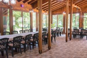 a dining room with a long table and chairs at Бунгала Камена - Bungalows Kamena in Kamena