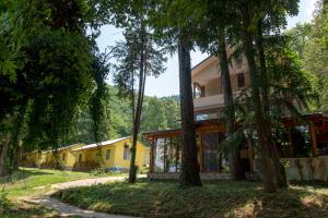 a house in the middle of a forest with trees at Бунгала Камена - Bungalows Kamena in Kamena